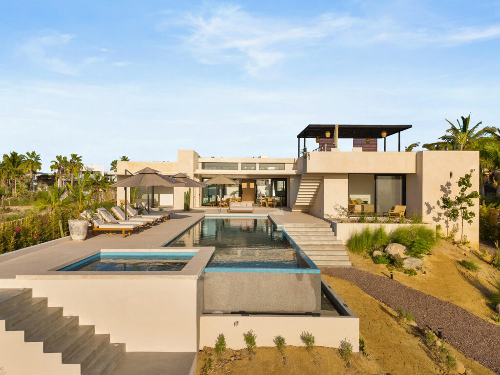 Los Cabos Luxury Las Tunas The Nacuii Residence is a refined luxury home crafted to exceed the expectations of even the most discerning buyer. Nestled on a generous and private 3,000 m² lot (0.73 acres), it's just a short, effortless stroll to the untouched, sandy shores of Las Tunas — perfect for enjoying the serene coastal landscape and dramatic sunsets. The home offers a thoughtful layout with 3 spacious bedrooms, a separate studio, a cozy TV lounge, and 6 full bathrooms, including two principal suites, a guest room, a detached studio, and a dedicated media or family room. Expansive sliding glass doors invite natural light throughout the interiors while showcasing tranquil garden – Calle Colibri, Pacific, BS