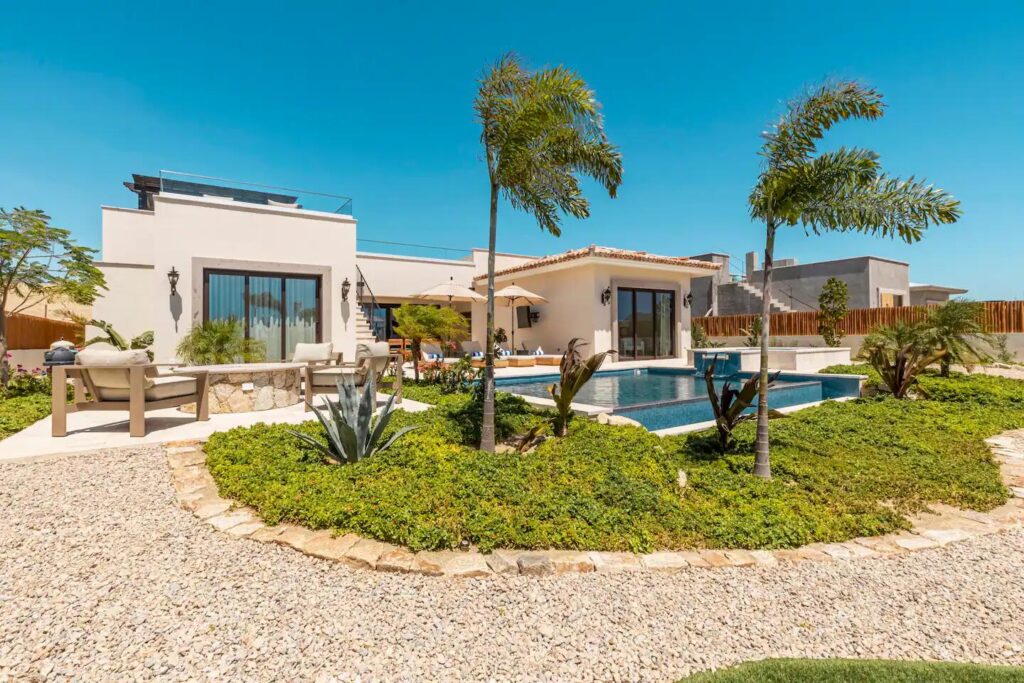 Los Cabos Luxury Las Tunas The Nacuii Residence is a refined luxury home crafted to exceed the expectations of even the most discerning buyer. Nestled on a generous and private 3,000 m² lot (0.73 acres), it's just a short, effortless stroll to the untouched, sandy shores of Las Tunas — perfect for enjoying the serene coastal landscape and dramatic sunsets. The home offers a thoughtful layout with 3 spacious bedrooms, a separate studio, a cozy TV lounge, and 6 full bathrooms, including two principal suites, a guest room, a detached studio, and a dedicated media or family room. Expansive sliding glass doors invite natural light throughout the interiors while showcasing tranquil garden – Los Colinas (Casas) #4, Pacific, BS